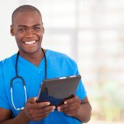 Happy nurse checks Ipad