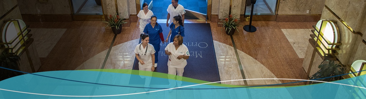 Medical work peers walk into the hospital together happily chatting