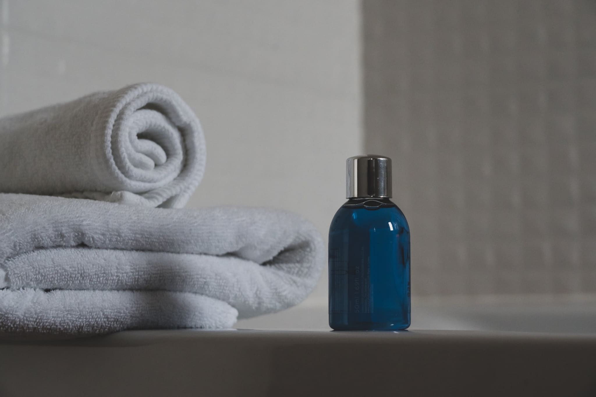 Bottle next to towels