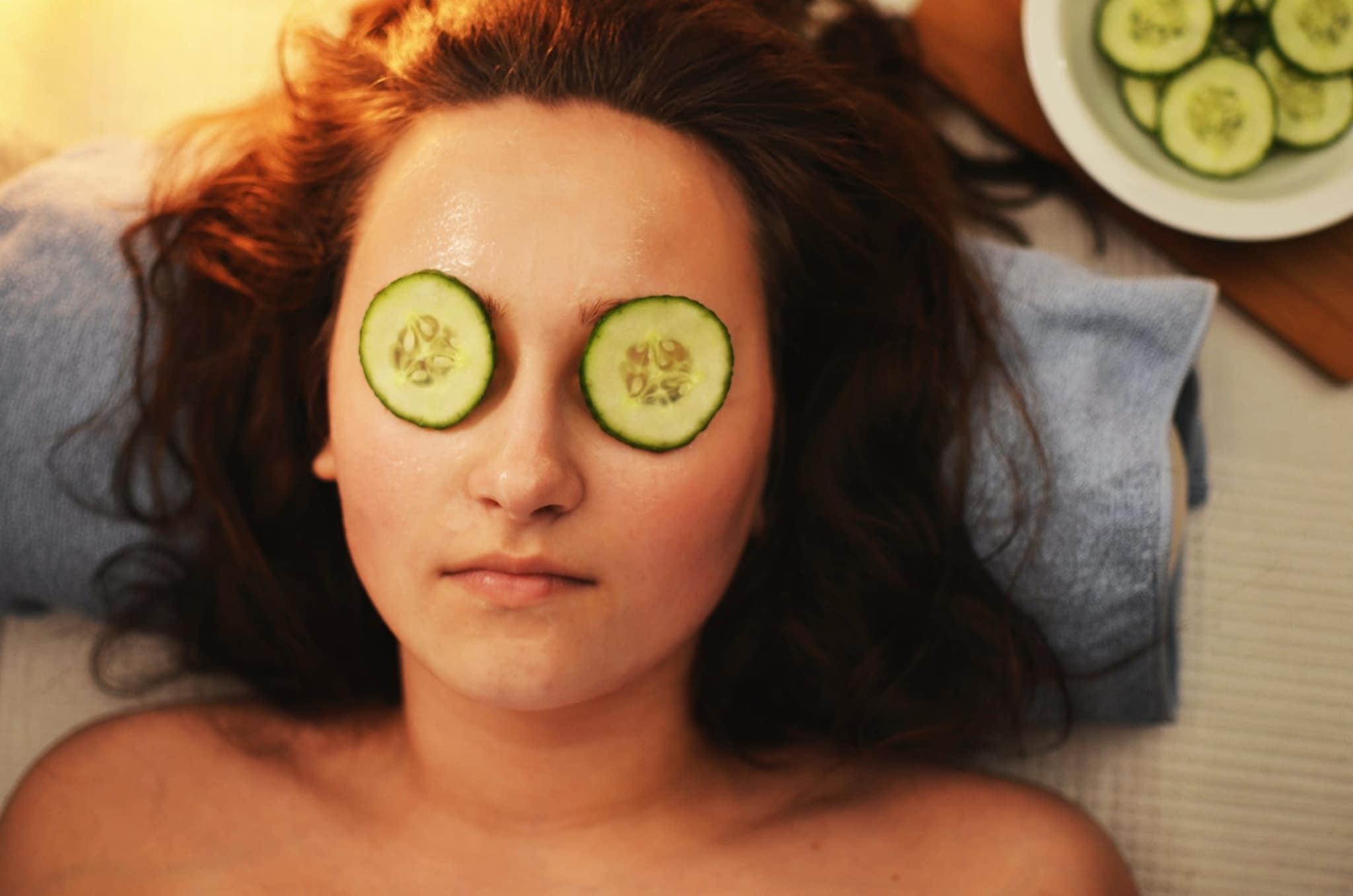 Woman wearing cucumber slices
