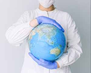 Nurse holding a globe