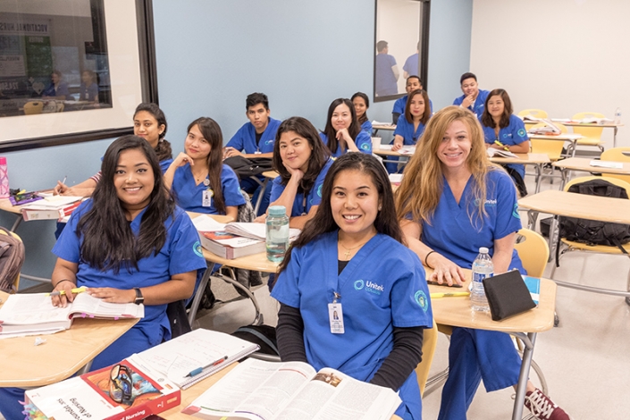 Diverse group of students sitting at their desks in a classroom