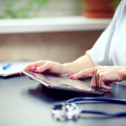 A woman with a stethoscope on a tablet