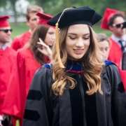 Smiling graduate in a gown and cap