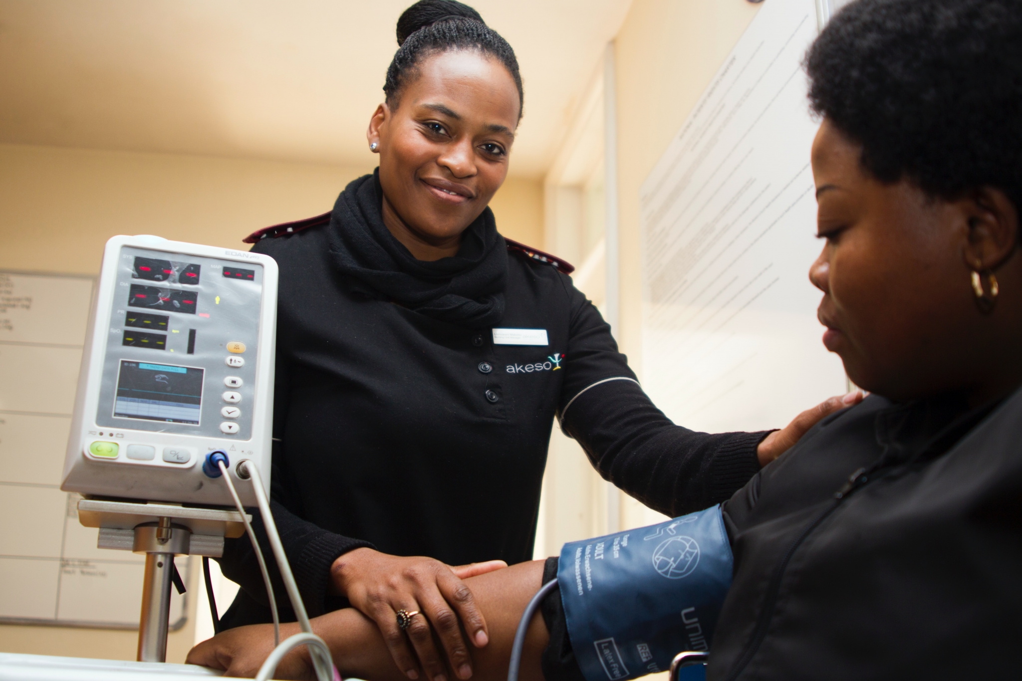 African-American nurse assisting a patient