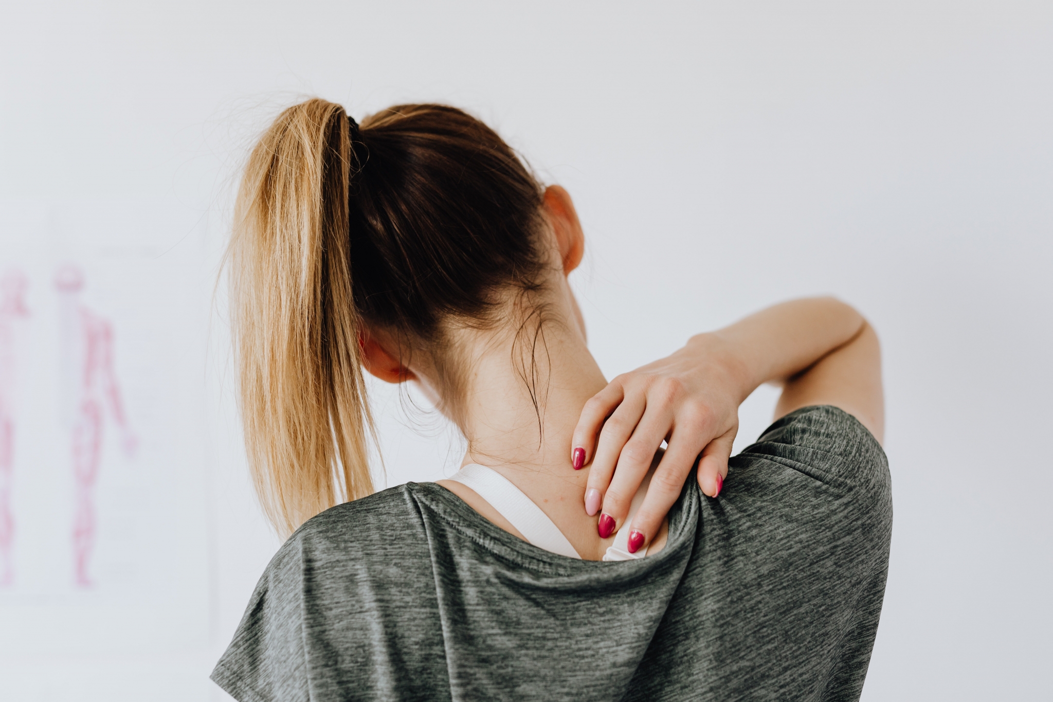 Blonde woman rubbing her back