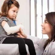 Healthcare professional examining a child