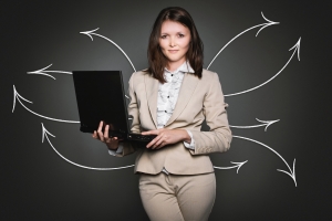 Female professional holding a laptop