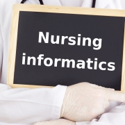 Medical professional holding nursing informatics sign