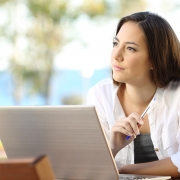Woman on a laptop looking thoughtful