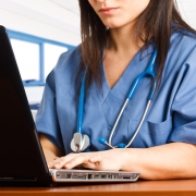 Close up of a medical professional on a laptop
