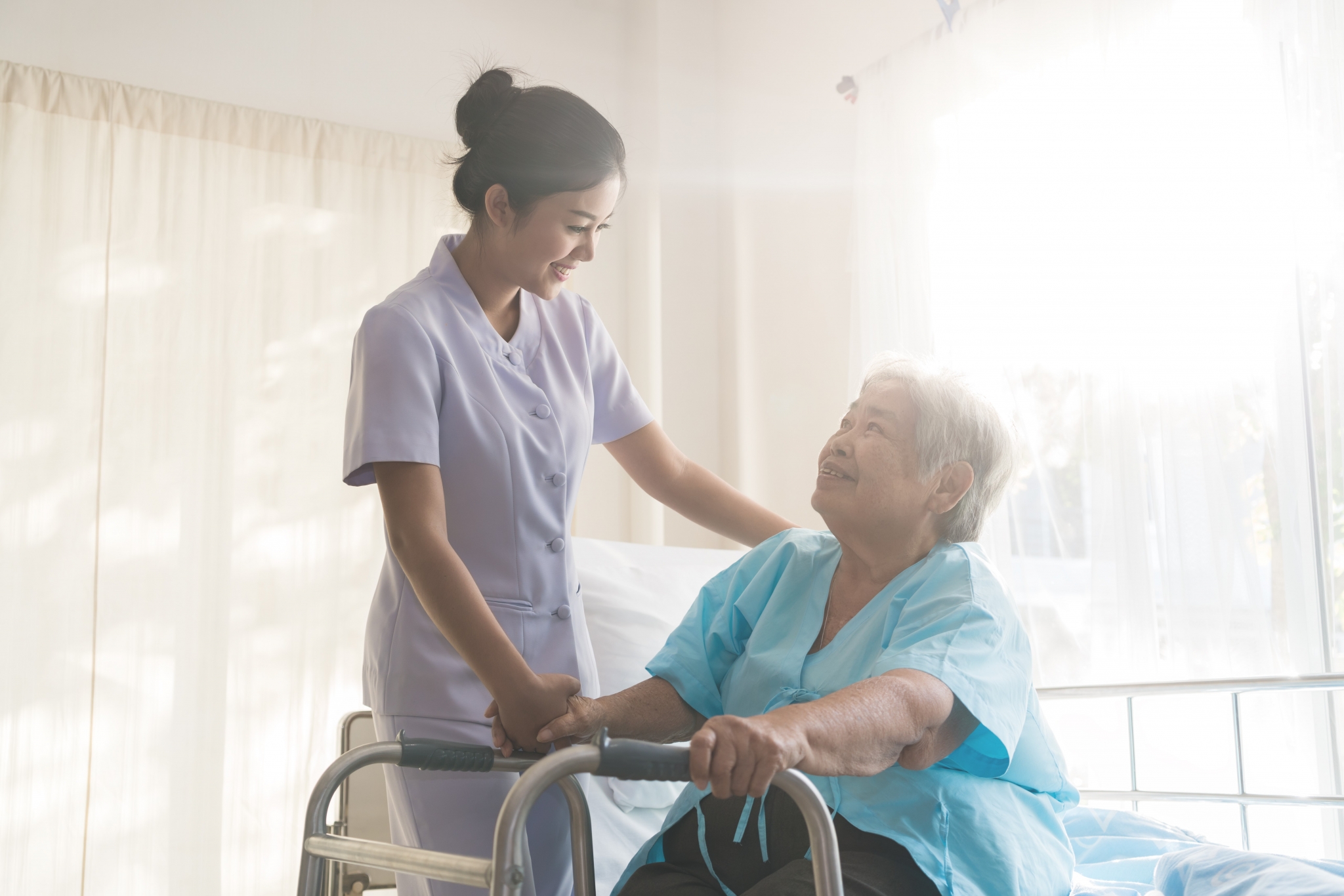 Young nurse helping an elderly woman