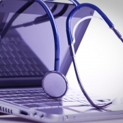 Stethoscope draped over a laptop