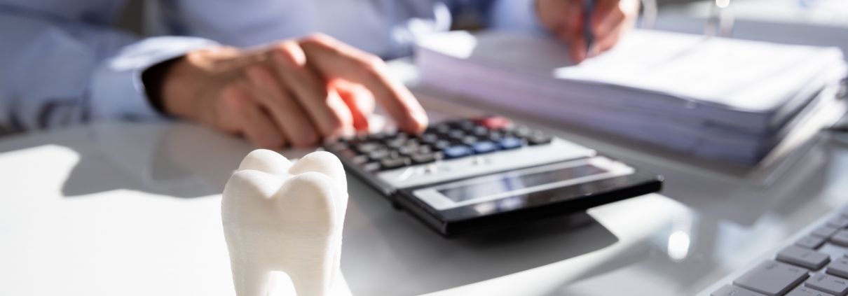 Close up of a tooth in front of an accountant