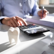 Close up of a tooth in front of an accountant