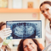 Dentist examining X-rays of teeth
