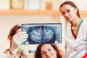 Dentist examining X-rays of teeth