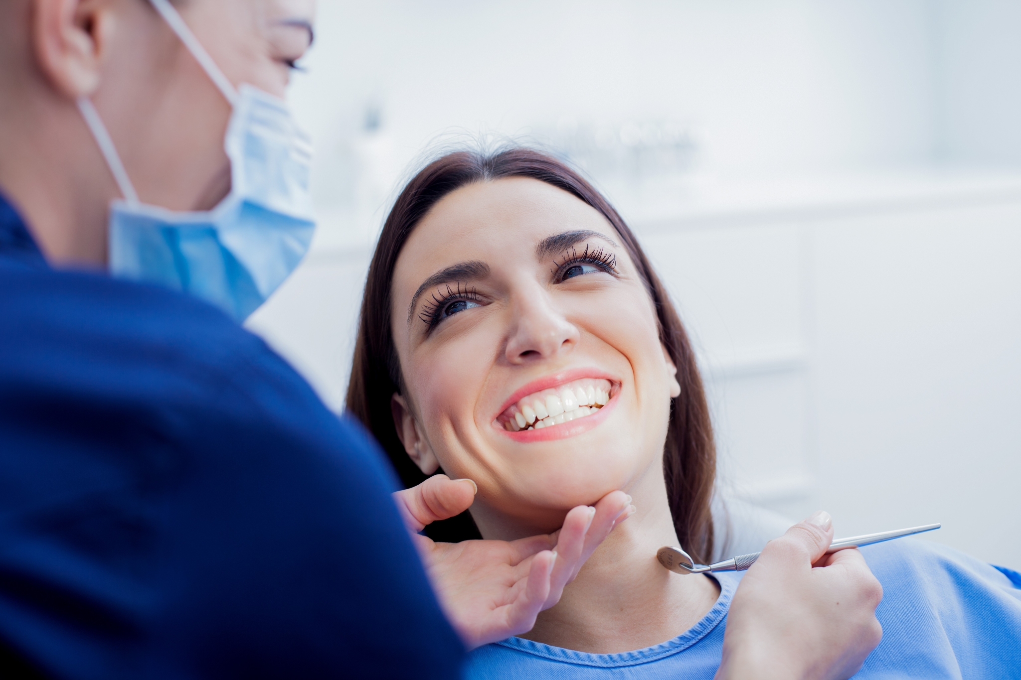 Woman smiling at a dental professional