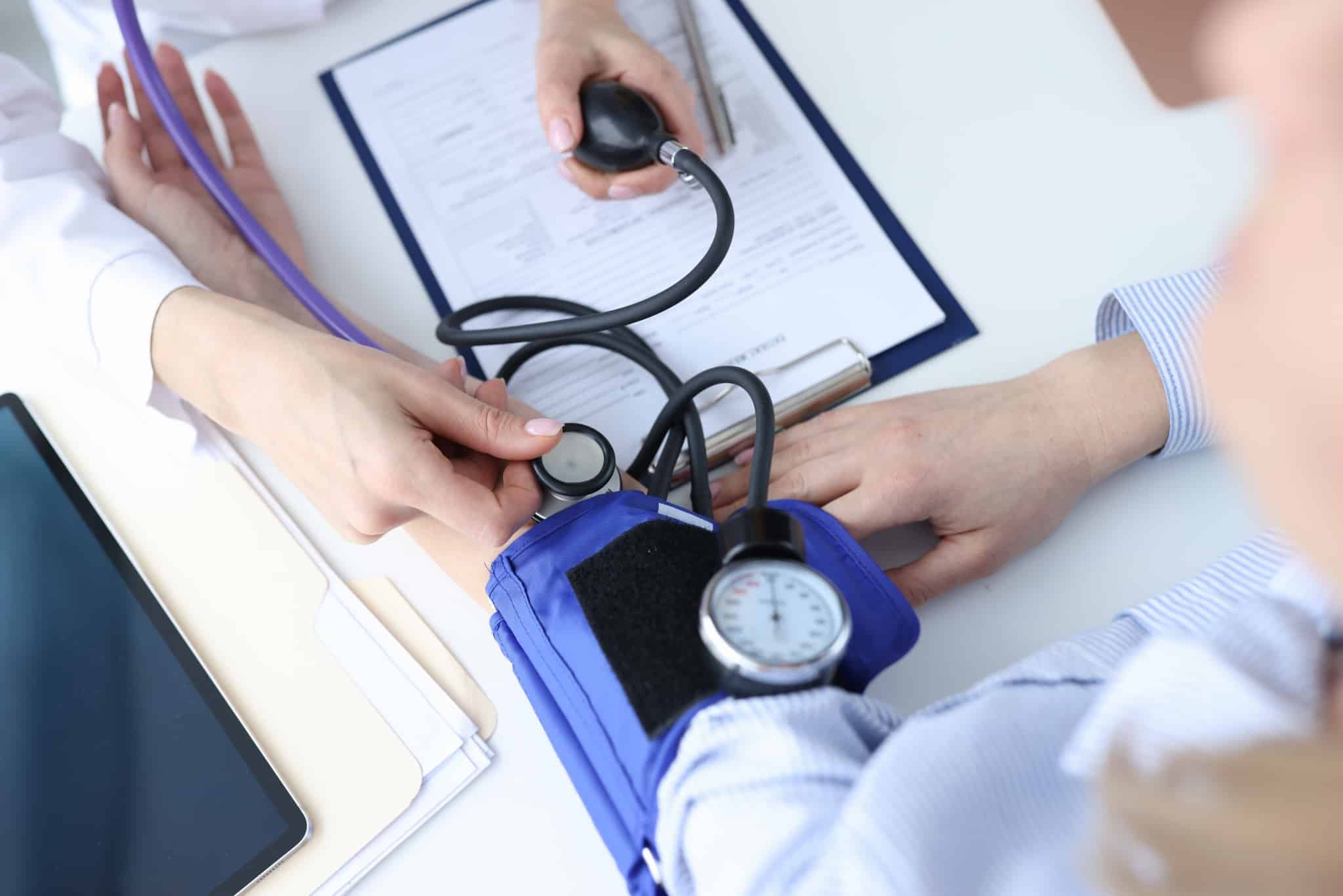 Medical professional taking blood pressure