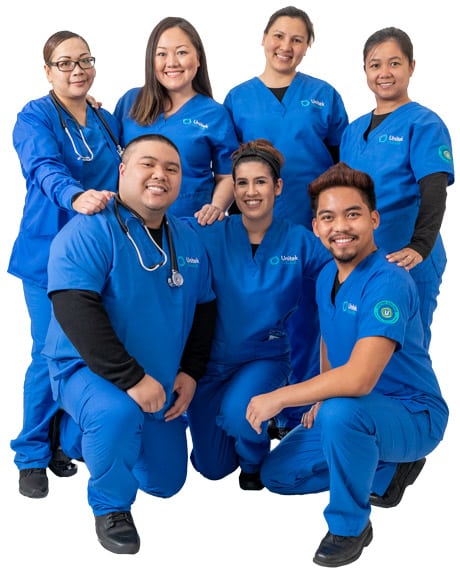 A group of nursing students in blue scrubs
