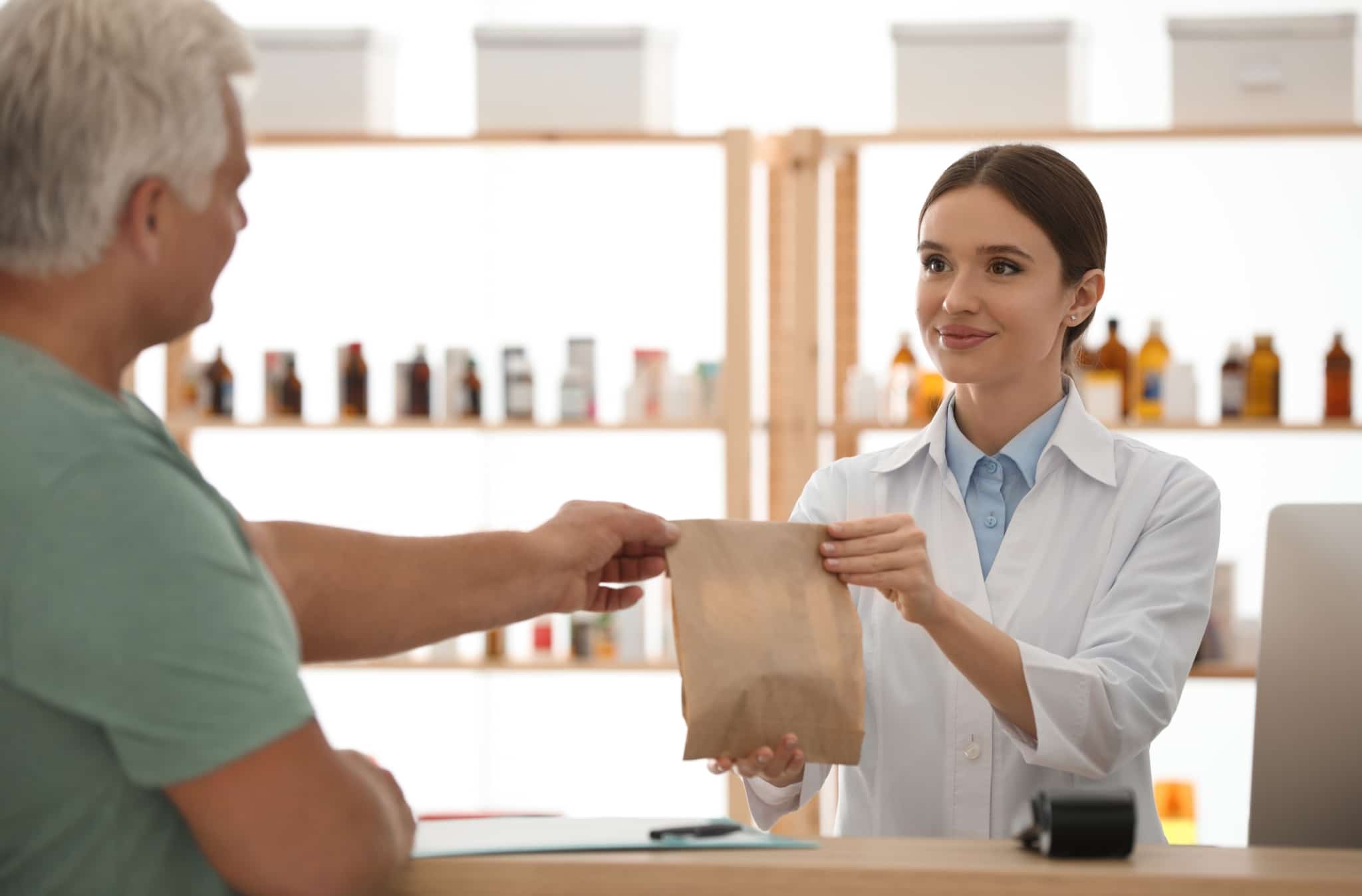 Pharmacy Technician giving medications to customer