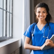 Smiling healthcare professional with clipboard