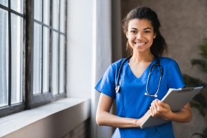 Smiling healthcare professional with clipboard