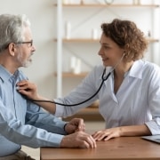 Medical professional taking a man's heartrate