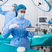 Nurse holding equipment in the operating room