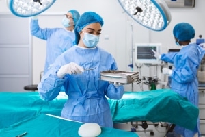 Nurse holding equipment in the operating room