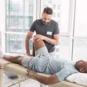 Physical therapy professional helping a patient