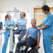 Physiotherapy professionals helping senior citizens exercise