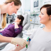 Phlebotomist drawing blood from a smiling woman